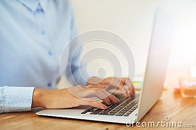 Hands of woman typing on laptop Stock Photo