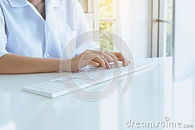 Hands woman using computer keyboard on desk in office room,Finger typing close up Stock Photo