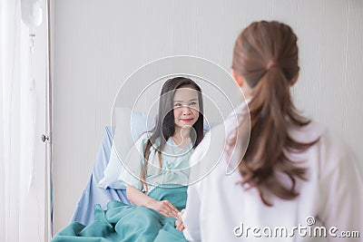 Hands women doctor reassuring her female asian patient in hospital room,Dentist giving a consultation and encouragement to patient Stock Photo