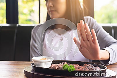 Hands woman refusing beef steak in restaurant,No meal,Vegetarian and vegan concept Stock Photo