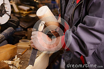 Hands woodcarver while working with the tools Stock Photo