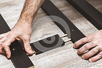 Hands, wooden structures. pieces of furniture. wooden fittings Stock Photo