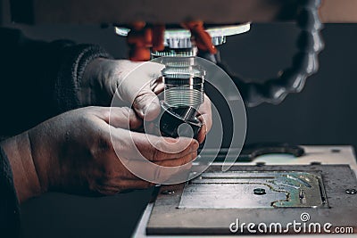 Hands of worker changing cutter in CNC milling machine Stock Photo