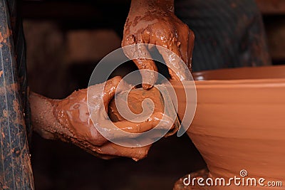 Hands working on crockery Stock Photo