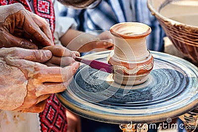 Hands working on pottery wheel. Sculptor, Potter. Human Hands creating a new ceramic pot. Stock Photo