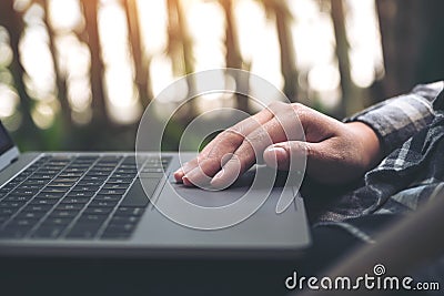 Hands working , touching and typing on laptop keyboard with blur nature background Stock Photo