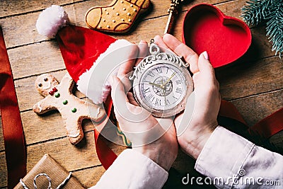 Hands wrapping christmas victorian clock Stock Photo