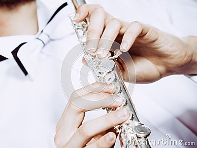 Hands of young man playing the flute Stock Photo