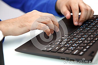 Hands of a young man typing on a laptop. the view from the top Stock Photo