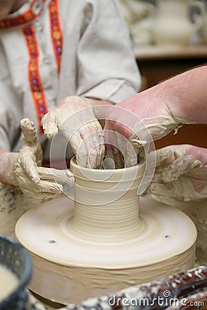 Hands of young potter kneading clay Stock Photo