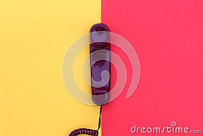 The handset lies on yellow and red colors. Stock Photo