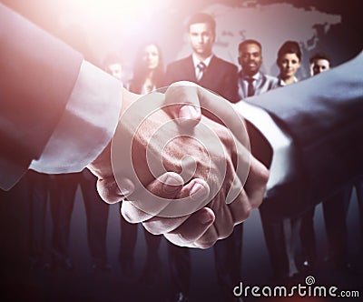 Handshake on the background group of business people in dark colors Stock Photo