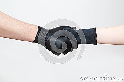 Handshake with black gloves during quarantine and epidemic. Stock Photo