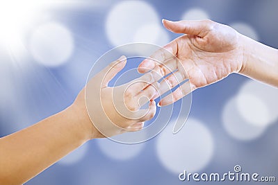 Handshake on blue defocused lights Stock Photo