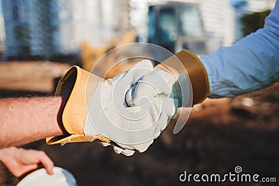 Handshake builders on the site Stock Photo