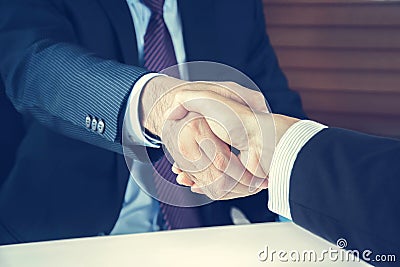 Handshake of businessmen in vintage tone Stock Photo