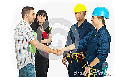 Handshake couple with constructor workers Stock Photo