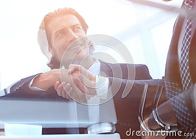 Handshake creative partner,sitting behind a Desk. Stock Photo