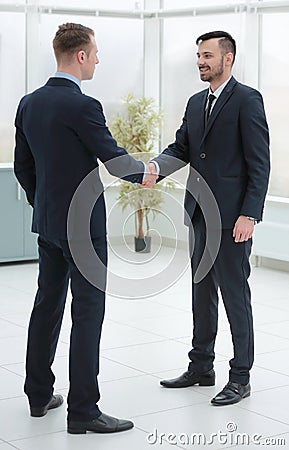 Handshake financial partners in the corridor of the office Stock Photo