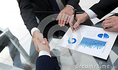 Handshake of financial partners at the Desk Stock Photo