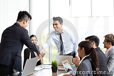 Handshake between the foreign CEO and the Asian manager who can successfully complete the project . Stock Photo