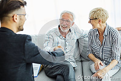 handshake senior couple investment business finance hand agent meeting agreement planning home Stock Photo