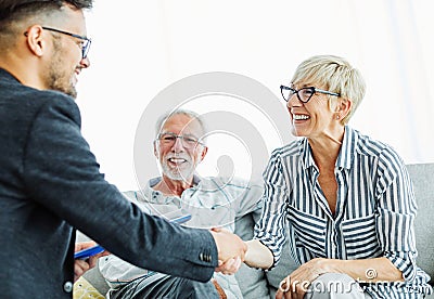 handshake senior couple investment business finance hand agent meeting agreement planning home Stock Photo