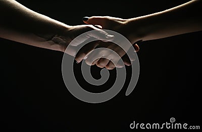 Handshake between the two partners. Rescue or helping gesture of hands. Concept of salvation. Hands of two people at the Stock Photo