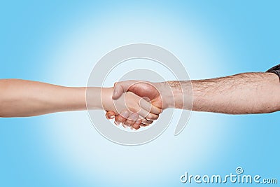 Handshake of a woman and a man on a blue background. Close up and copy space.Concept of viral pandemic, disinfection and Stock Photo