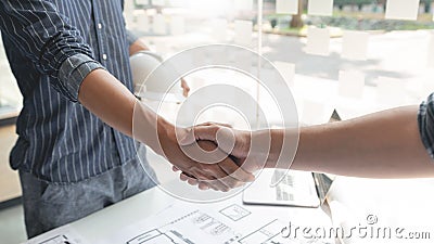 Handshaking between an architect and a contractor of agreement after collaboration Stock Photo