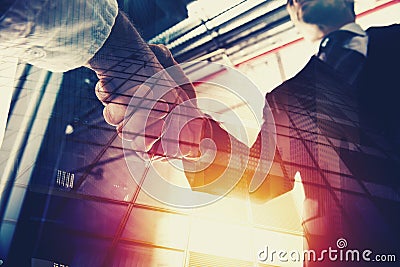 Handshaking business person in office. concept of teamwork and partnership. double exposure Stock Photo