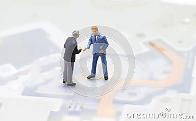 Handshaking businessmen and technology background. Computing or internet industry. Stock Photo