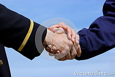 Handshaking pilot and airplane mechanic Stock Photo