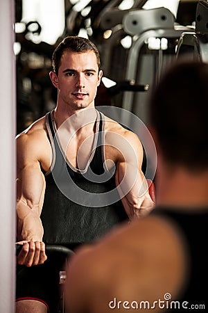 Handsom young man workout in fitness gym Stock Photo