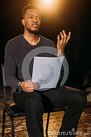 African american actor holding scenario on Stock Photo