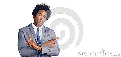 Handsome african american man with afro hair wearing business jacket pointing to both sides with fingers, different direction Stock Photo