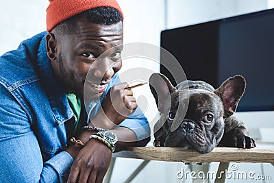 Handsome african american man with Frenchie dog Stock Photo