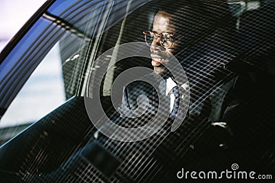 Handsome african elegant serious man drives a car Stock Photo