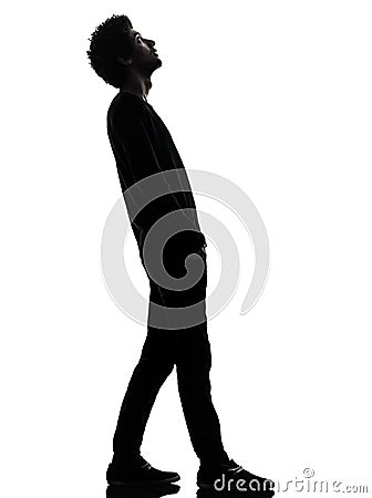 handsome african young man standing looking up surprise silhouette Stock Photo