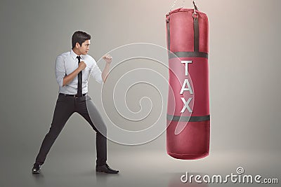 Handsome asian businessman ready to punch boxing bag with tax te Stock Photo