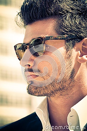 Handsome and attractive young man outdoor with sunglasses Stock Photo