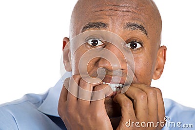 Handsome bald man scared and afraid with fingers in mouth Stock Photo