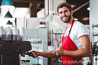 Handsome barista preparing a cup of coffee Stock Photo