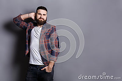 Handsome bearded hipster touching his hair Stock Photo