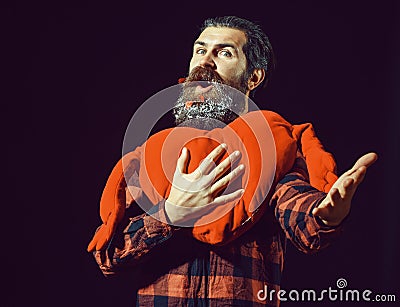 Handsome bearded man or guy in checkered shirt with fashionable mustache and red decorated hearts with snow in beard Stock Photo