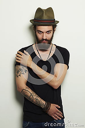 Handsome bearded man in hat.Brutal boy with tattoo Stock Photo