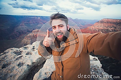Handsome bearded man makes selfie photo on travel hiking at Grand Canyon in Arizona Stock Photo