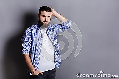 Handsome bearded man touching his hair Stock Photo