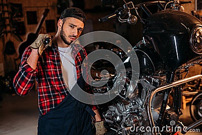 handsome bike repair station worker with wrench in front Stock Photo