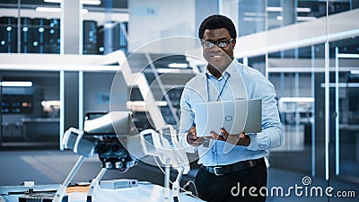 Handsome Black Man Wearing Glasses Smiling Charmingly and Looking at Camera. Young Intelligent Male Stock Photo